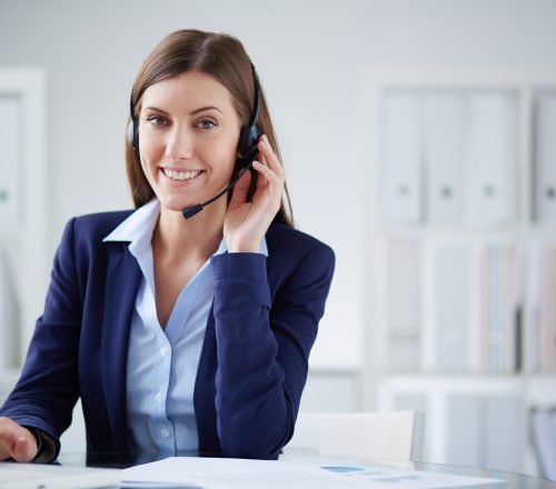 Young businesswoman with headset working in office